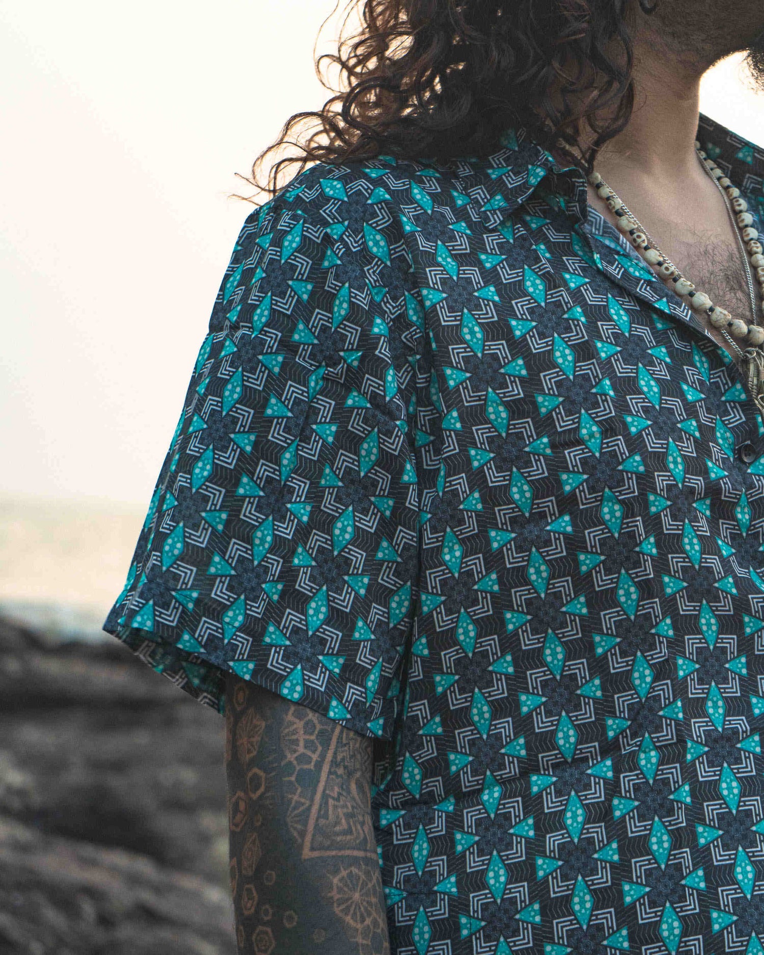 Model wearing Pebble Daze men's bamboo short sleeve shirt, perfect lightweight fashion made from eco-friendly sustainable fabrics.