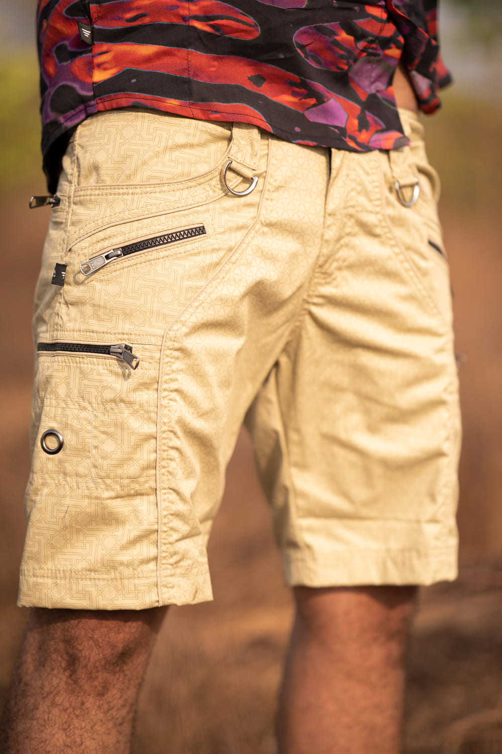 Beige Shri Yantra cargo shorts over knee with multiple zipper pockets and sacred pattern