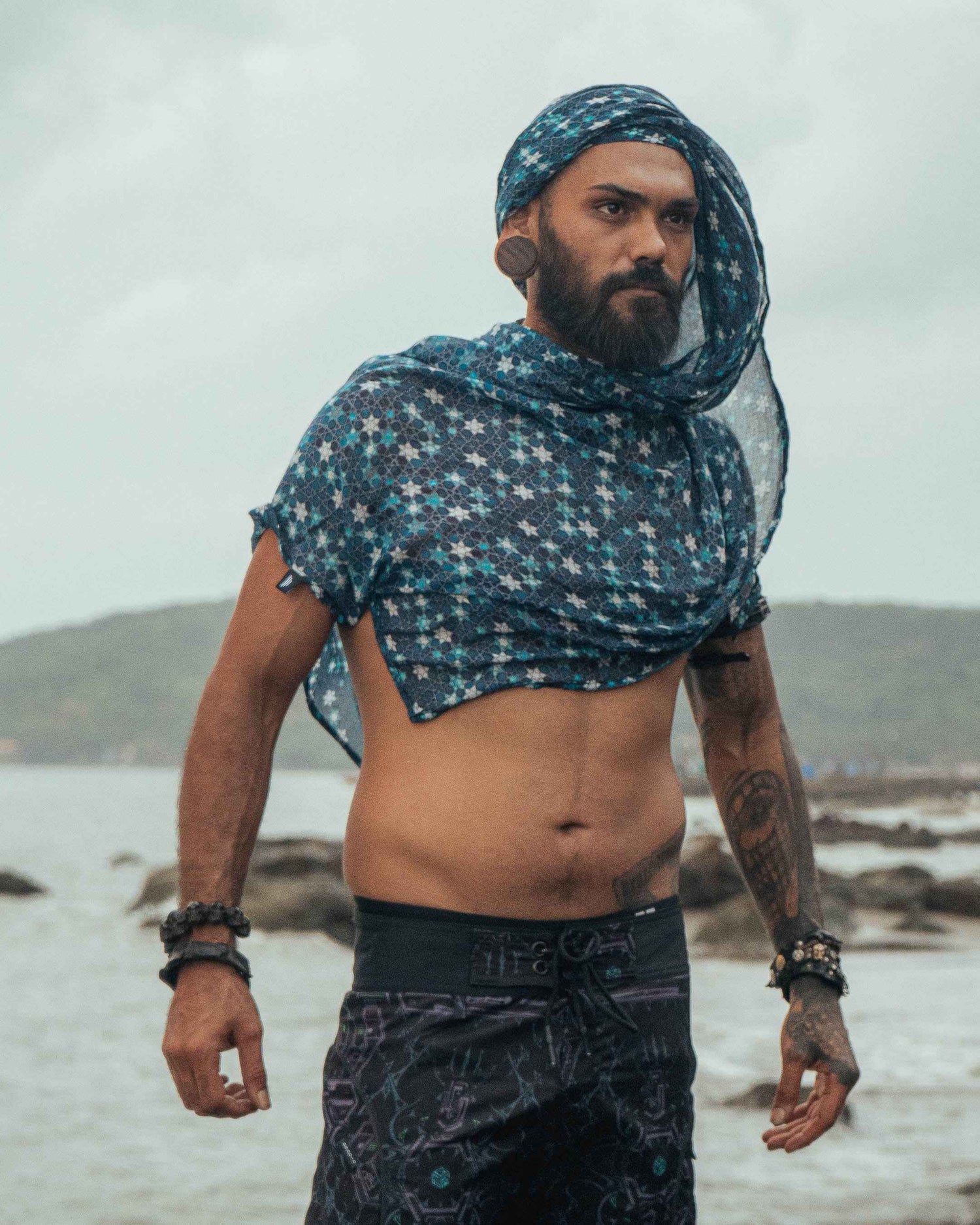 Realm of Metatron bamboo scarf featuring sacred geometry print worn as a hooded festival scarf