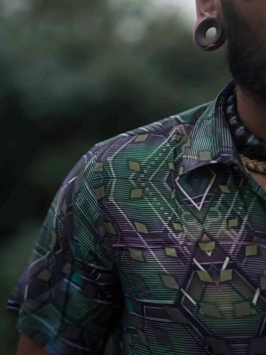 Close-up of a man wearing a bamboo shirt with psychedelic geometric print, showcasing breathable fabric and detailed pattern design.