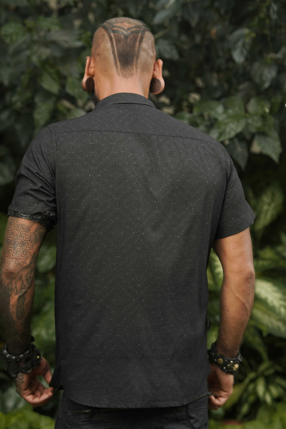 Back view of a men's short sleeve viscose shirt in black with abstract screen-printed pattern, ideal for casual summer wear.