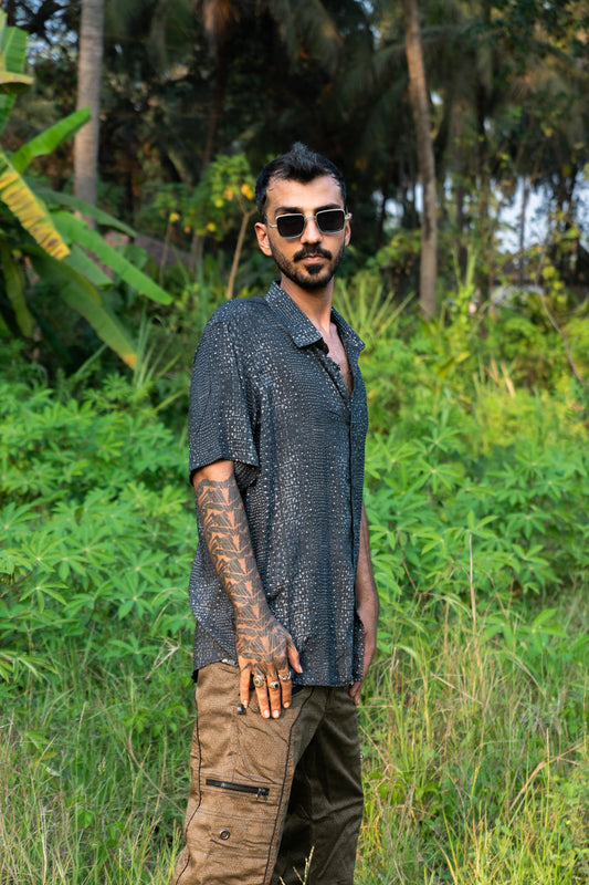 Model wearing Black Illusions bamboo breathable summer shirt with trippy abstract print
