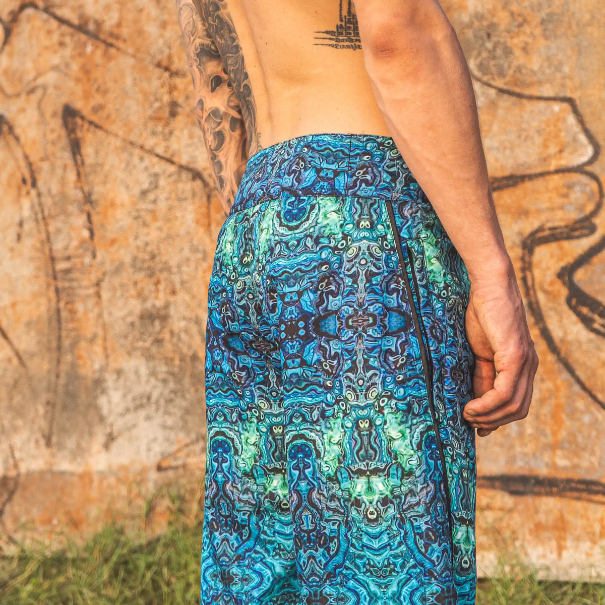men wearing psychedelic printed swim shorts full body