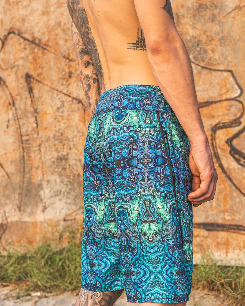 men wearing psychedelic printed swim shorts full body