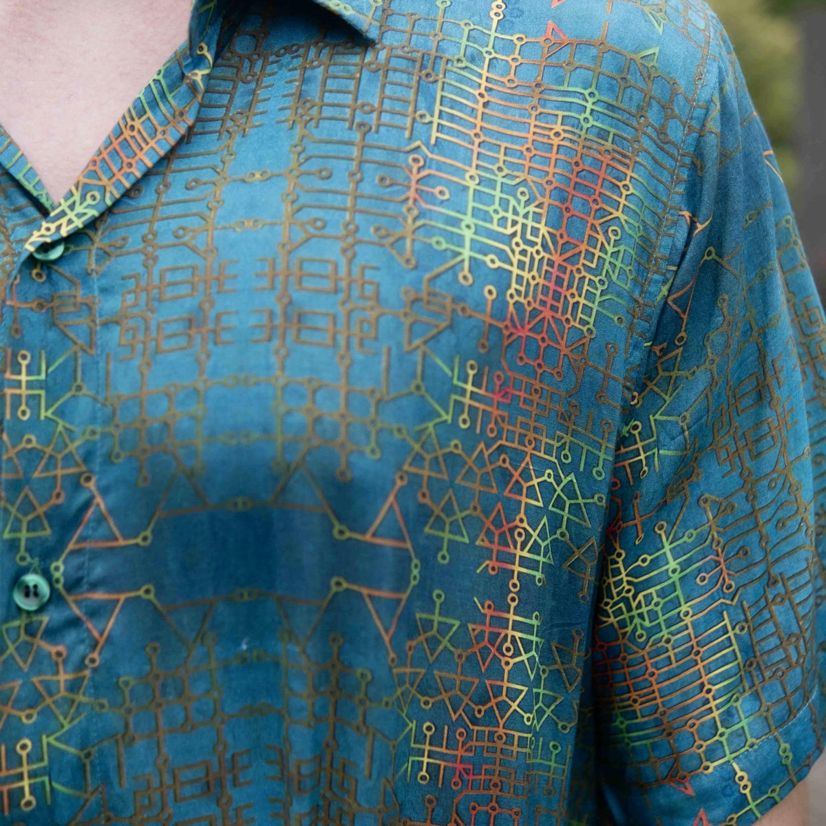 Close-up of blue bamboo summer shirt showing geometric art print