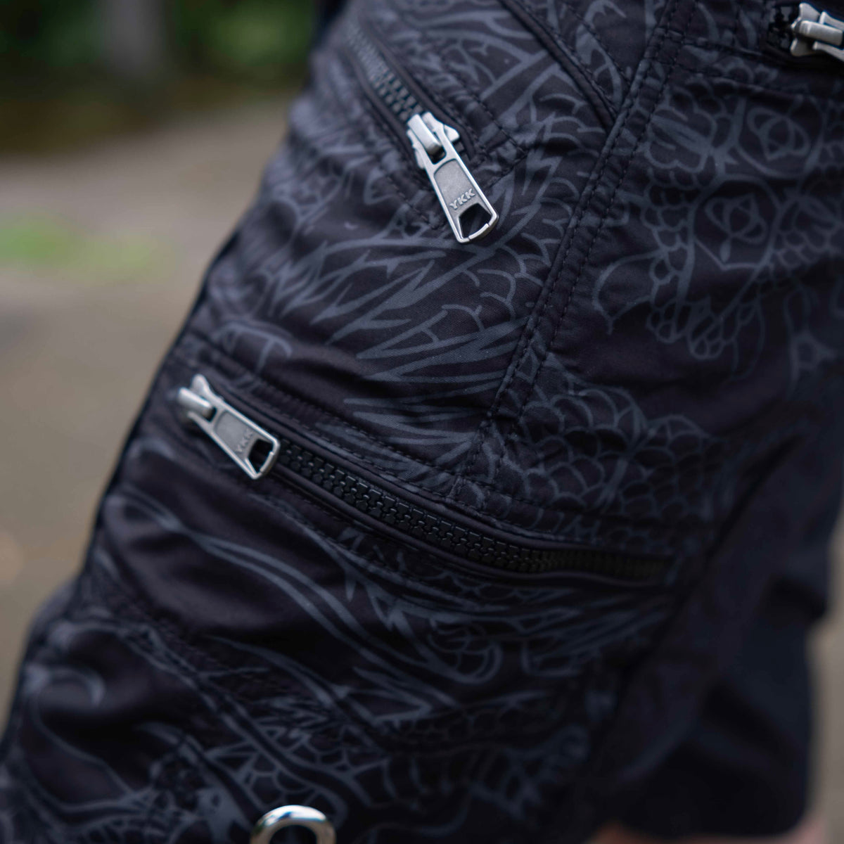 Black above knee men’s cargo shorts featuring multiple cargo pockets with durable YKK zippers