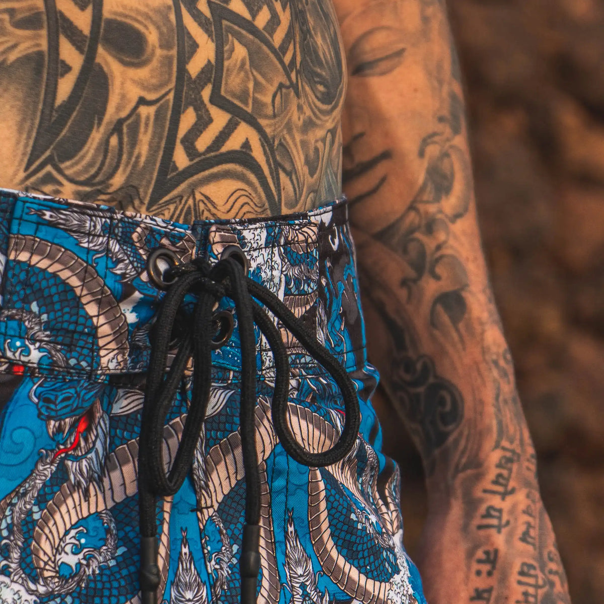 men wearing dragon printed swim shorts festival design