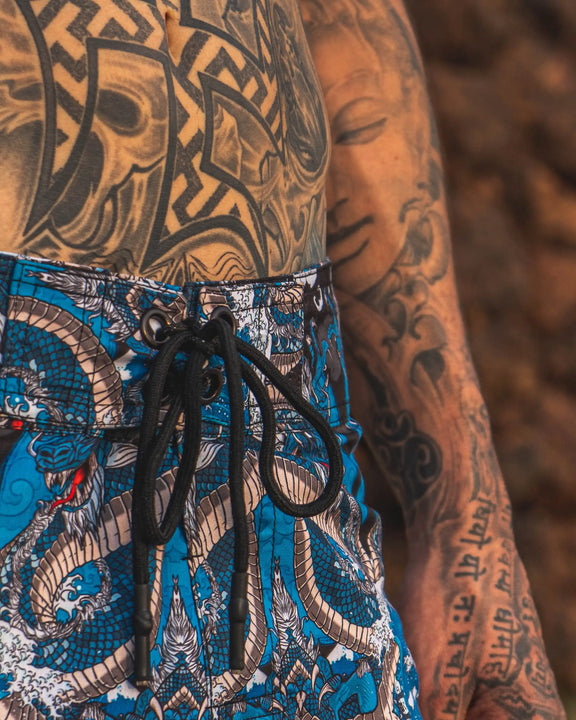men wearing dragon printed swim shorts festival design