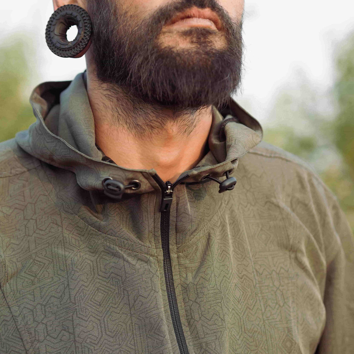 Close up of Magma Codex psychedelic rave windbreaker jacket with sacred geometry digital print