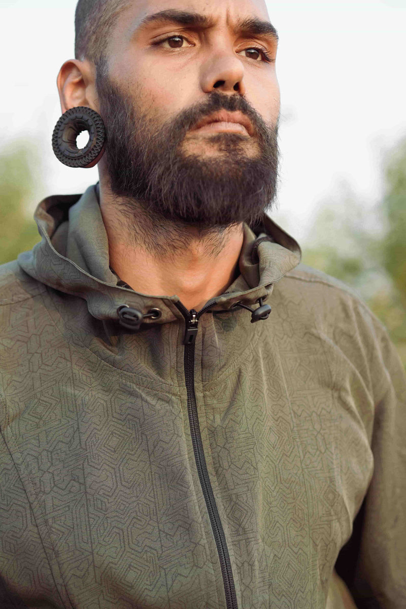 Close up of Magma Codex psychedelic rave windbreaker jacket with sacred geometry digital print