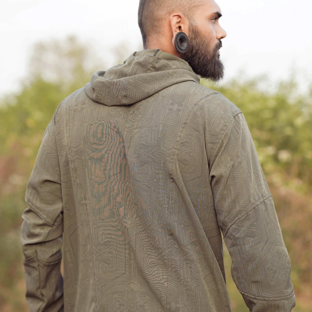 Khaki psychedelic windbreaker jacket back view with Metanoia geometric pattern and hood