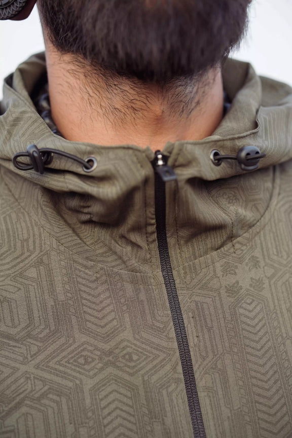 Khaki psychedelic windbreaker jacket front view with adjustable hood drawstrings and zipper