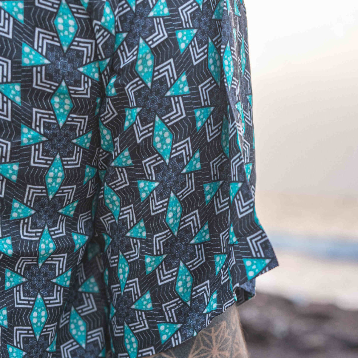 Close-up of men's bamboo short sleeve shirt, Pebble Daze, featuring geometric neo-cyberpunk print and crafted from sustainable fabrics.