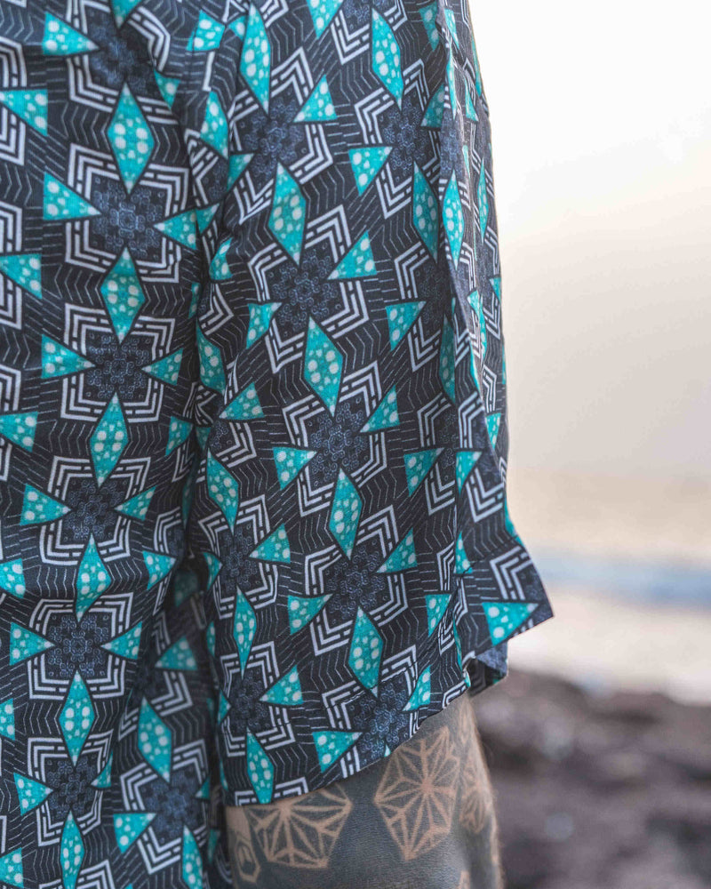 Close-up of men's bamboo short sleeve shirt, Pebble Daze, featuring geometric neo-cyberpunk print and crafted from sustainable fabrics.