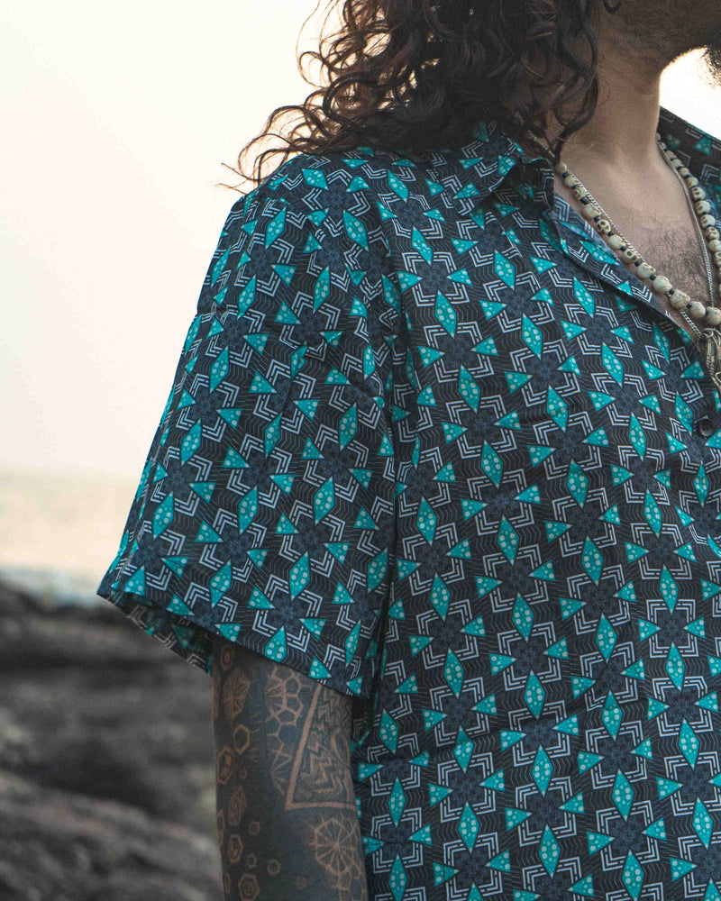 Model wearing Pebble Daze men's bamboo short sleeve shirt, perfect lightweight fashion made from eco-friendly sustainable fabrics.
