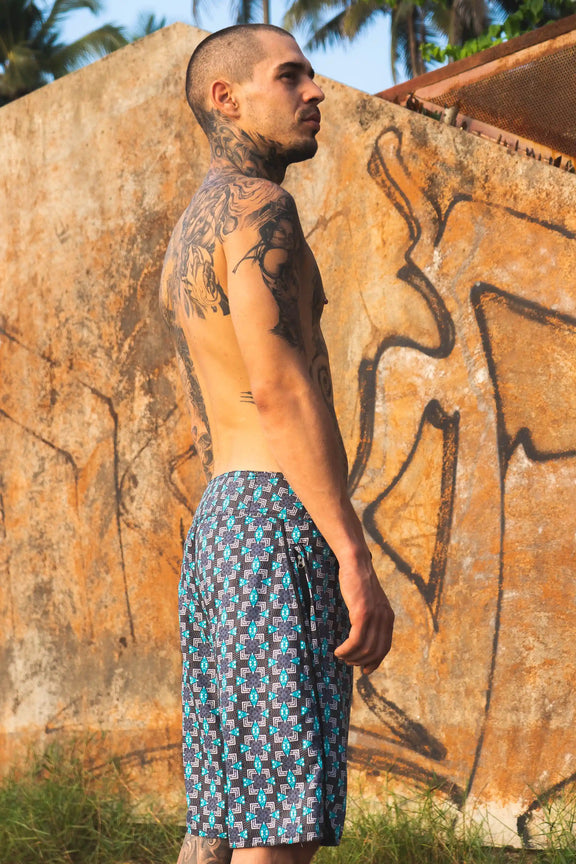 geometric print board shorts men side profile beachwear