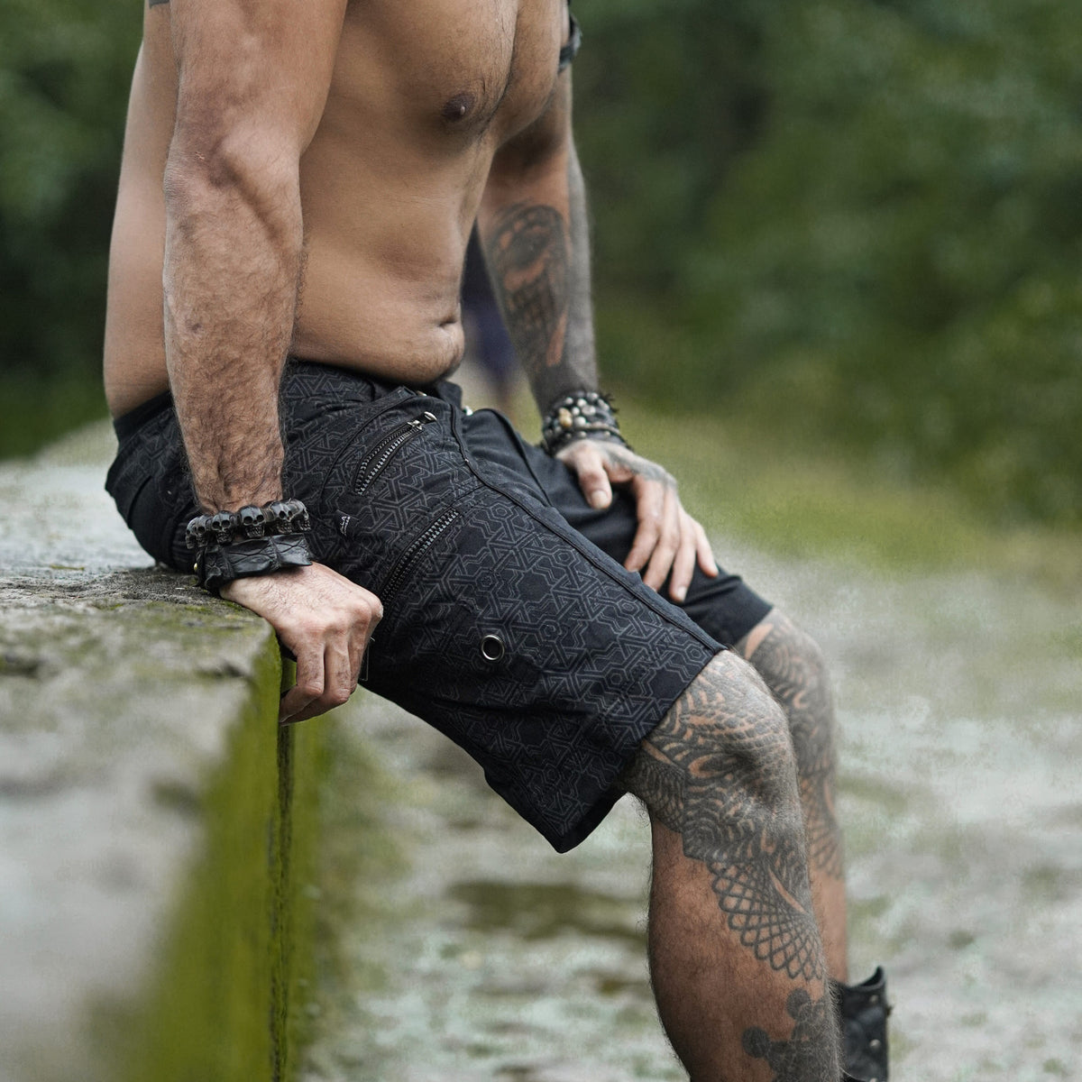 pythagoras jet black above the knee shorts men side sitting view