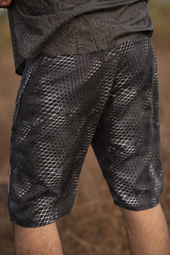 psychedelic python print swim shorts side view textured pattern