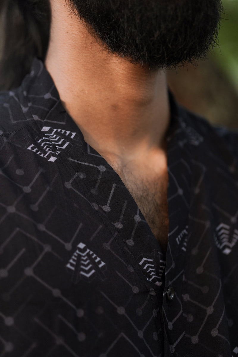 Detail of bamboo modal sleeveless shirt collar showing lightweight fabric and geometric psychedelic pattern
