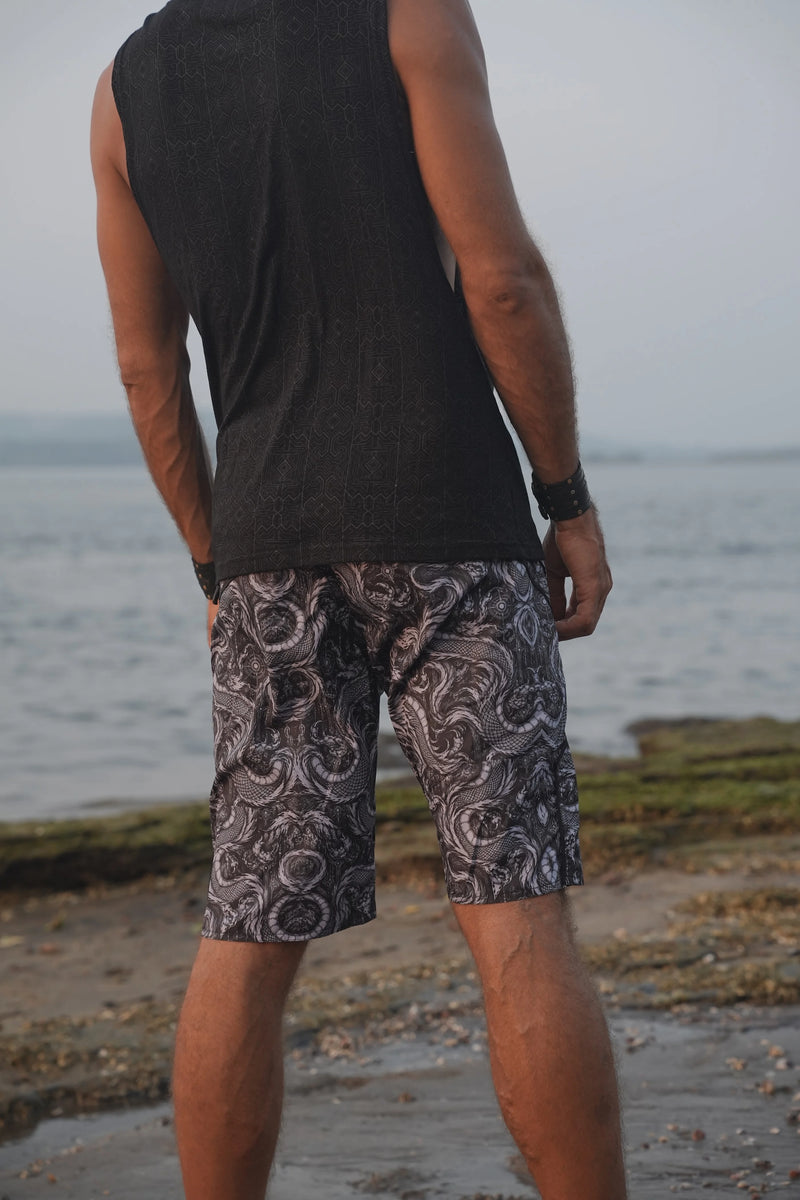 Rear view of men's Abstract Dragon psychedelic board shorts displaying the all-over black, grey and white dragon pattern.
