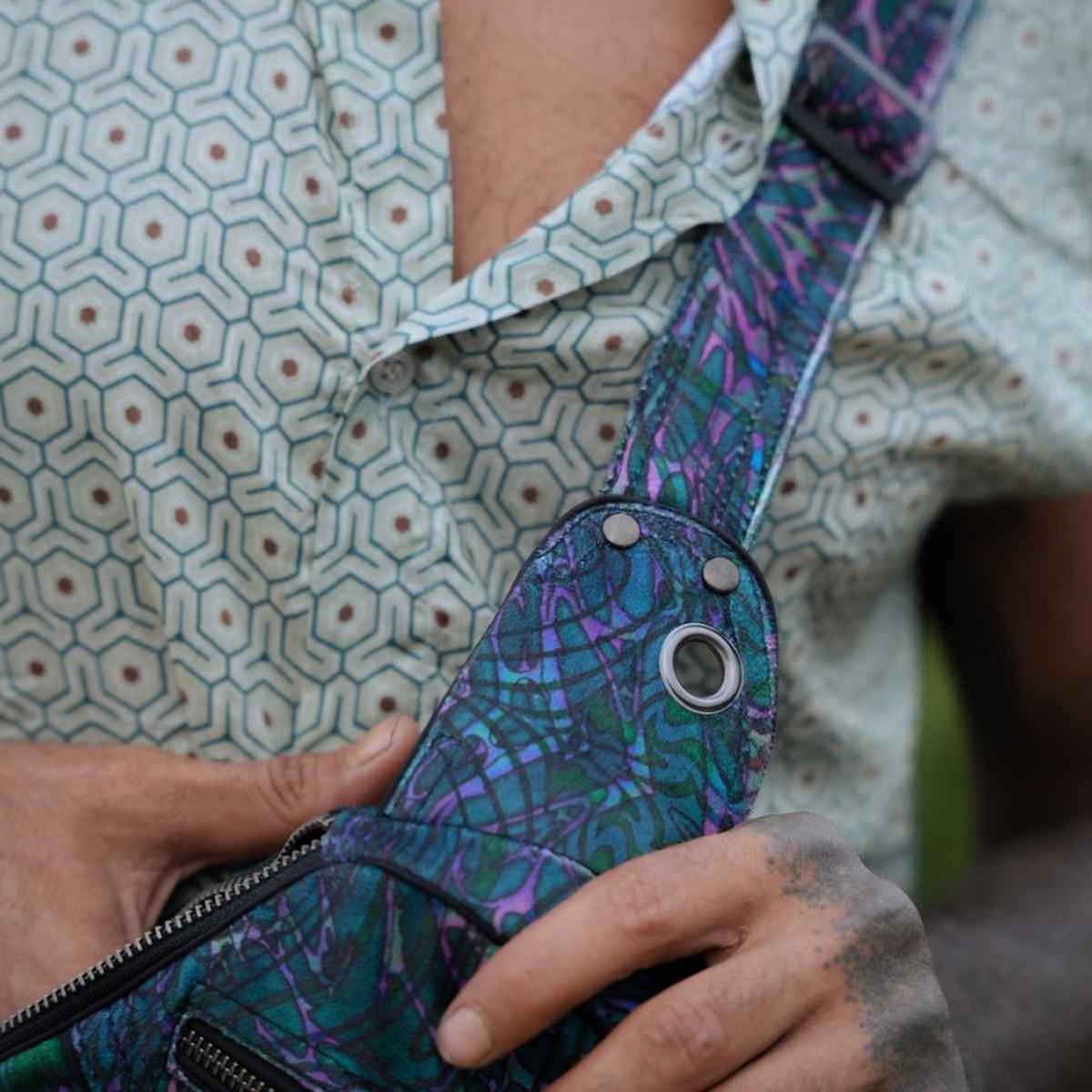 After Burn psychedelic festival crossbody bag close-up showing front zip pocket and adjustable strap