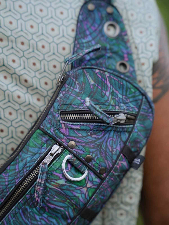 After Burn festival crossbody bag close-up showing front zipper compartments and metal D-ring