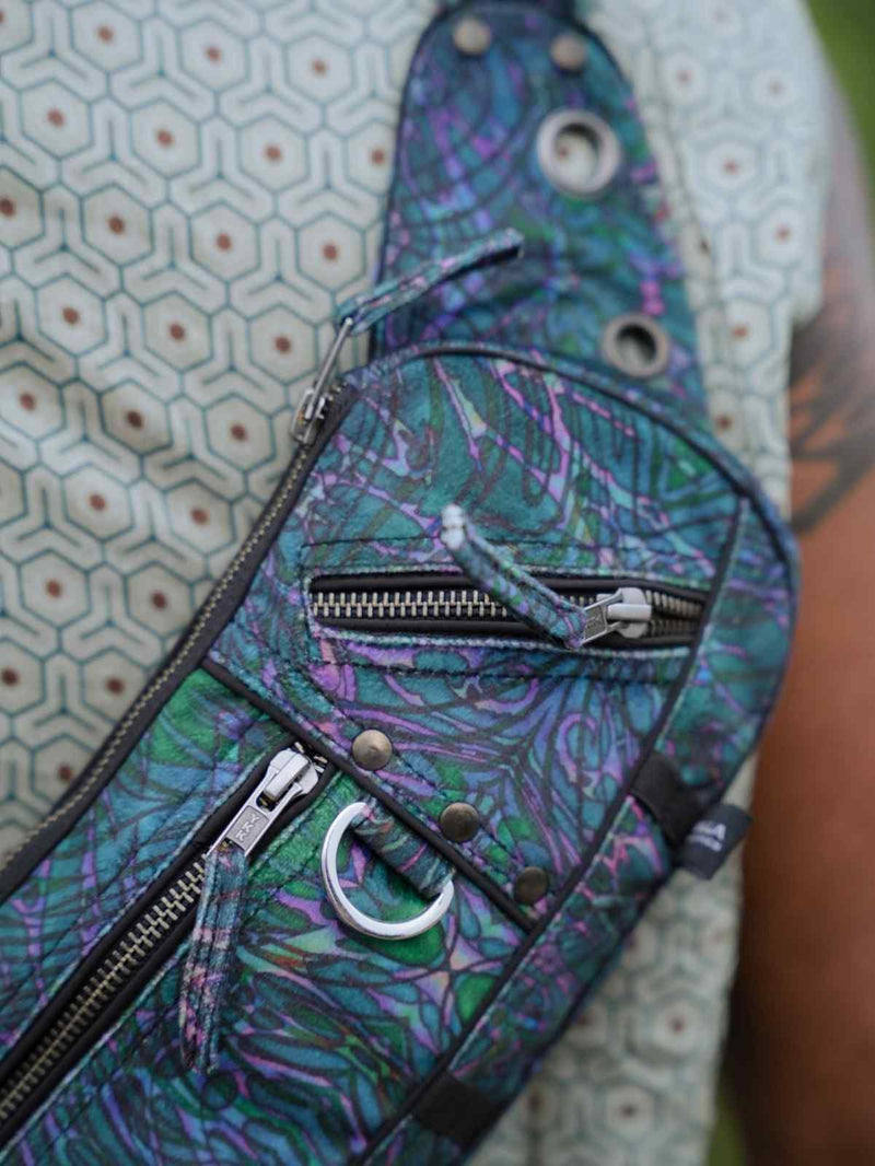 After Burn festival crossbody bag close-up showing front zipper compartments and metal D-ring