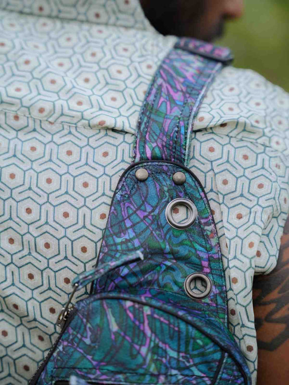 After Burn crossbody bag close-up showing patterned strap and metal eyelets