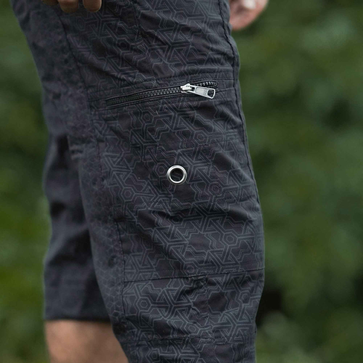 Close-up of black psychedelic geometric pattern on 3/4 cargo shorts