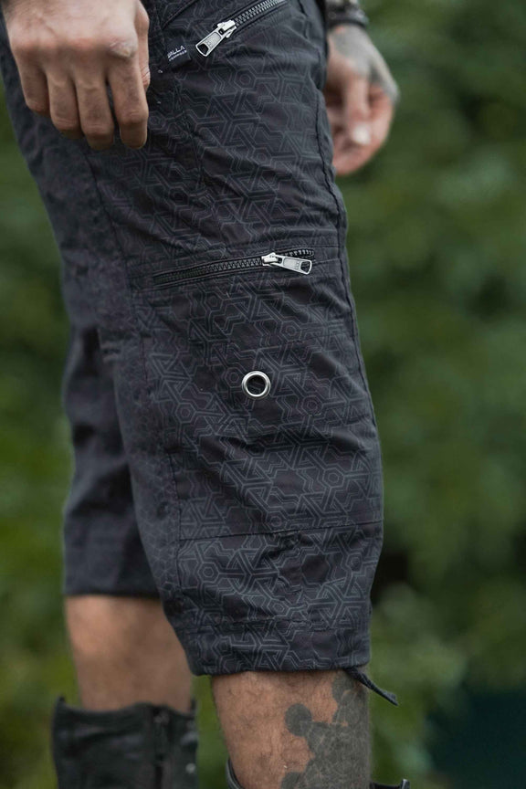 Close-up of black psychedelic geometric pattern on 3/4 cargo shorts