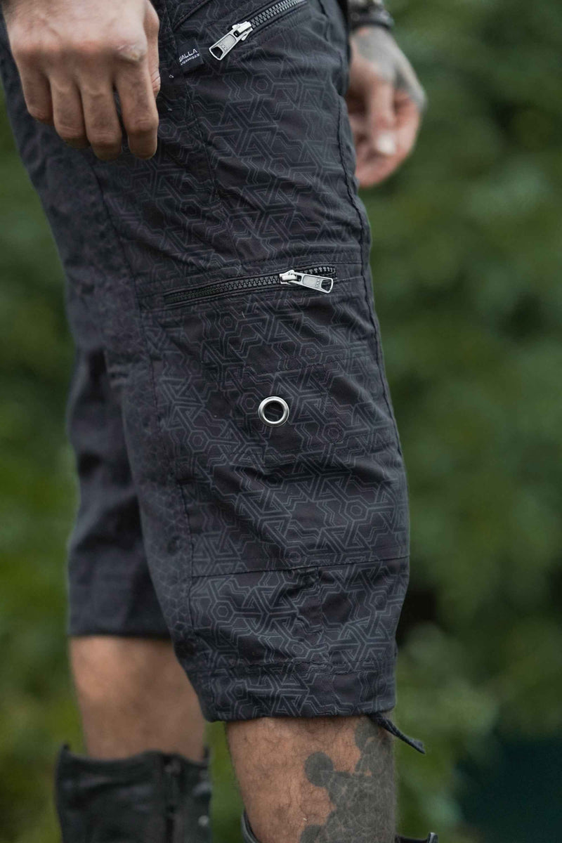 Close-up of black psychedelic geometric pattern on 3/4 cargo shorts