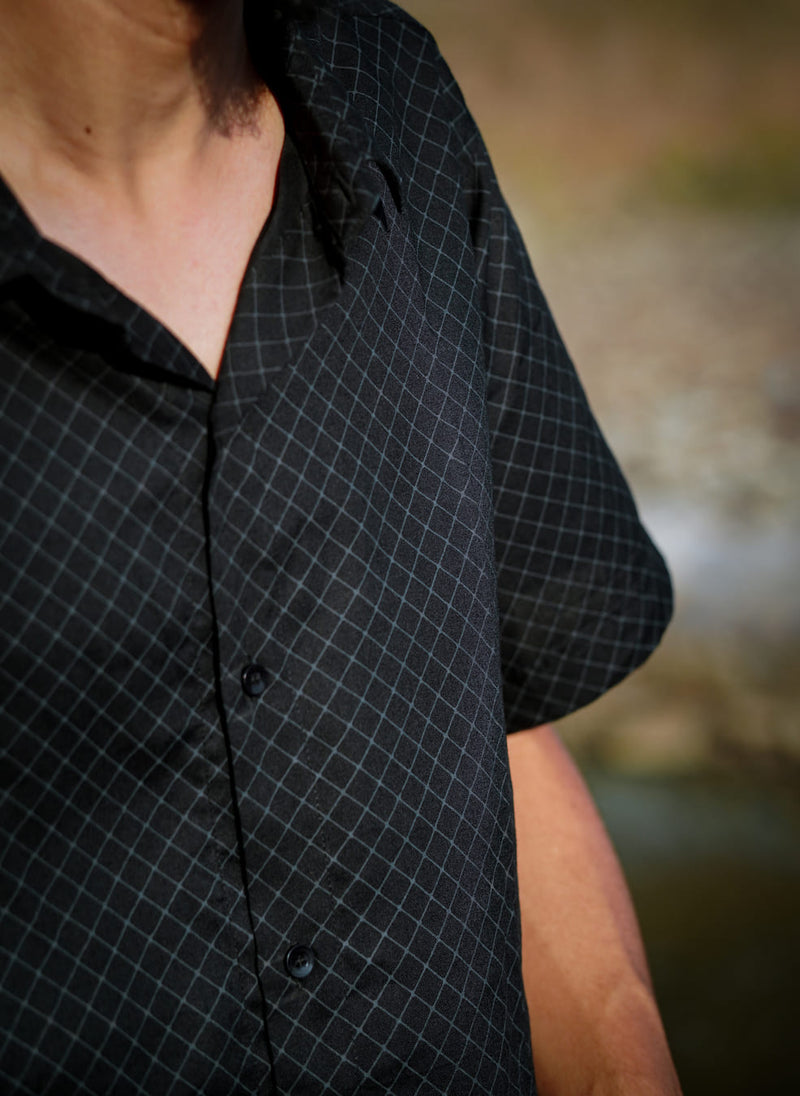 Close-up of black VAAYU viscose button down shirt with premium geometric pattern