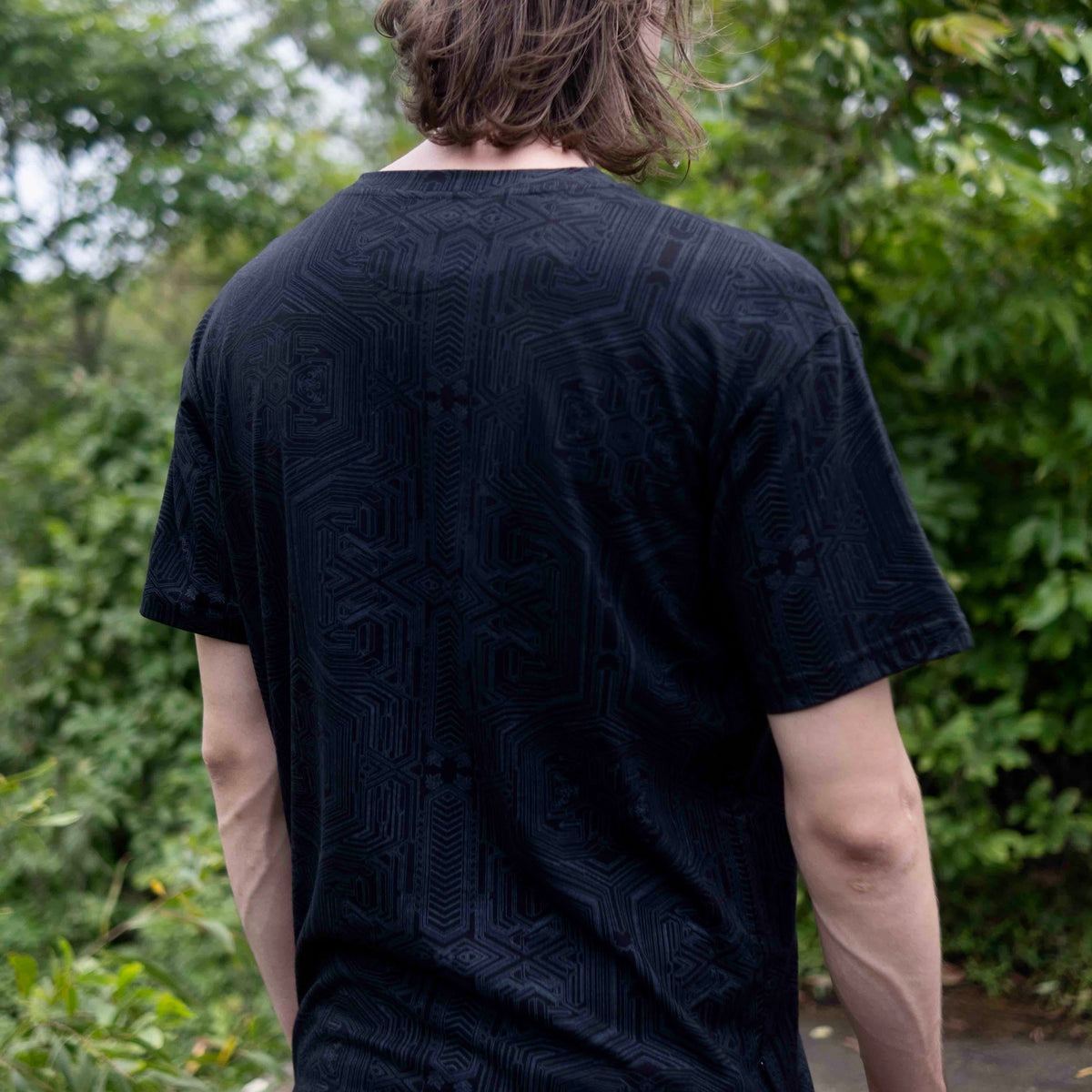 Back view of Metanoia black sacred geometry t shirt featuring all-over geometric artwork by Baabio