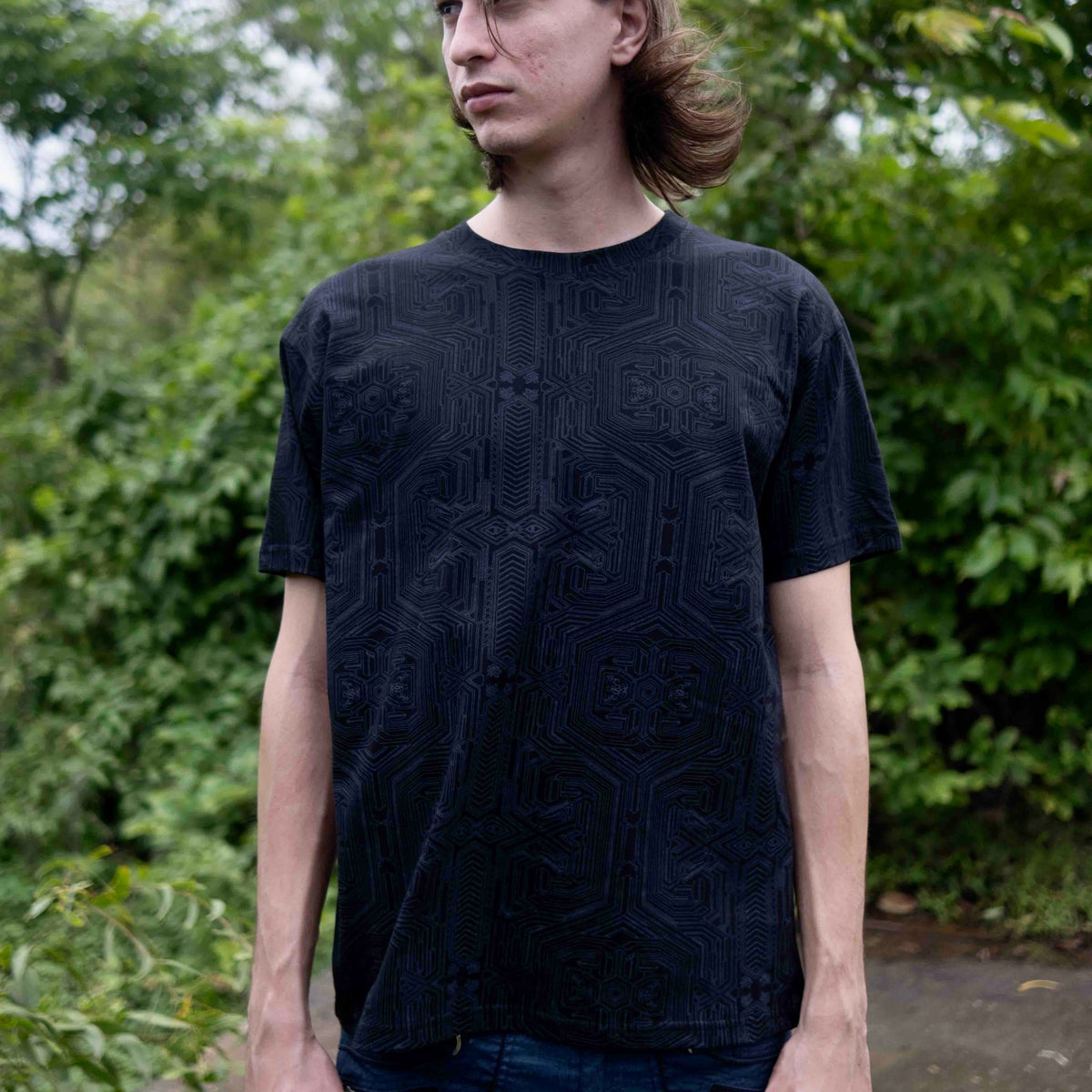 Model wearing Metanoia black psychedelic t shirt with subtle sacred geometry design
