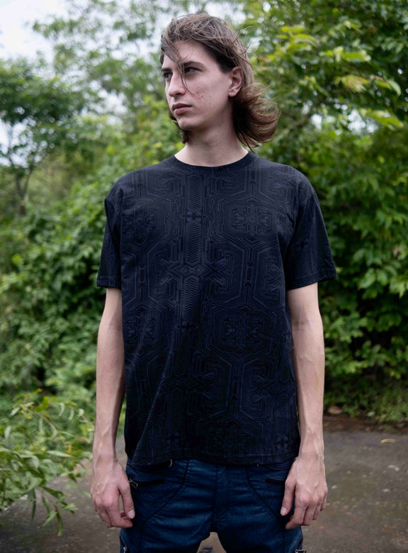 Model wearing Metanoia black psychedelic t shirt with subtle sacred geometry design