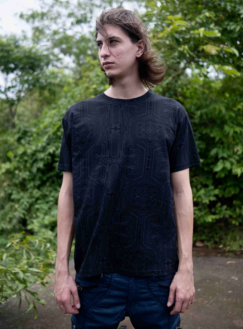 Model wearing Metanoia black psychedelic t shirt with subtle sacred geometry design