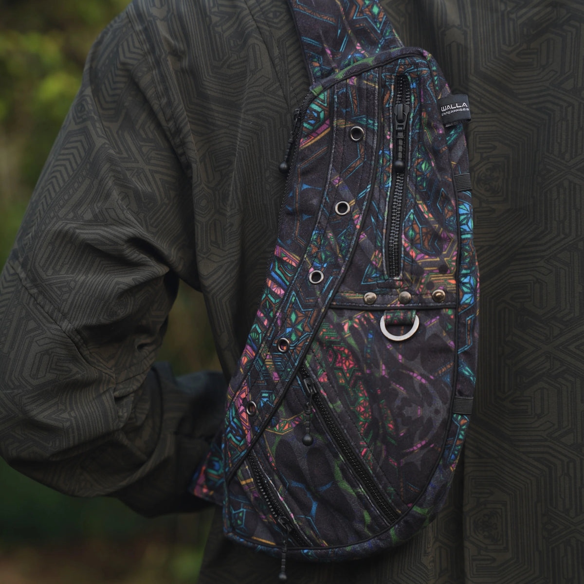 Detailed view of the Aztech 2.0 crossbody bag's patterned strap, metal eyelets and front hardware
