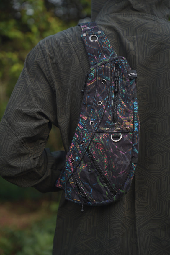 Detailed view of the Aztech 2.0 crossbody bag's patterned strap, metal eyelets and front hardware