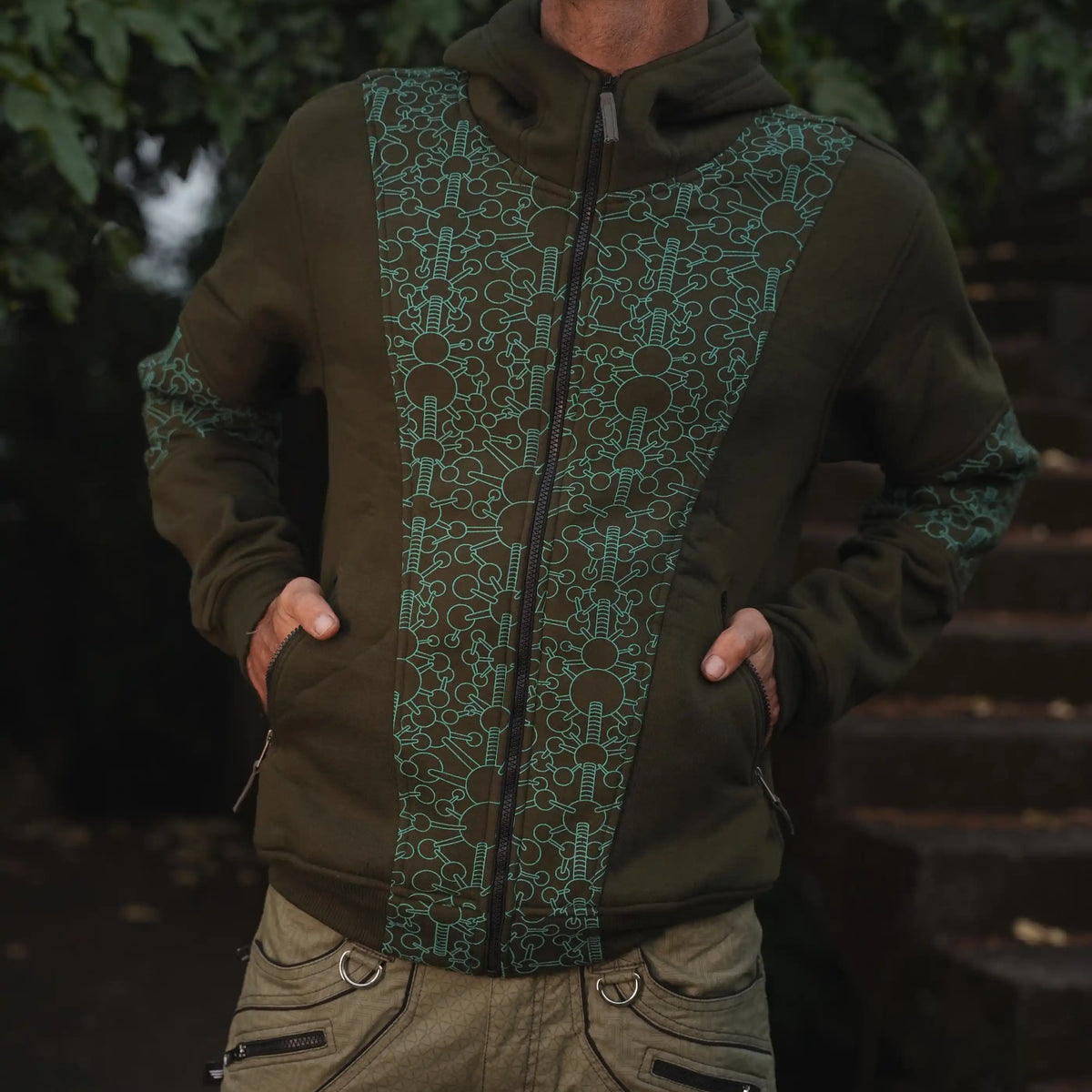 Man wearing the Fractal Gravity green psychedelic hoodie with geometric print and full-length front zipper
