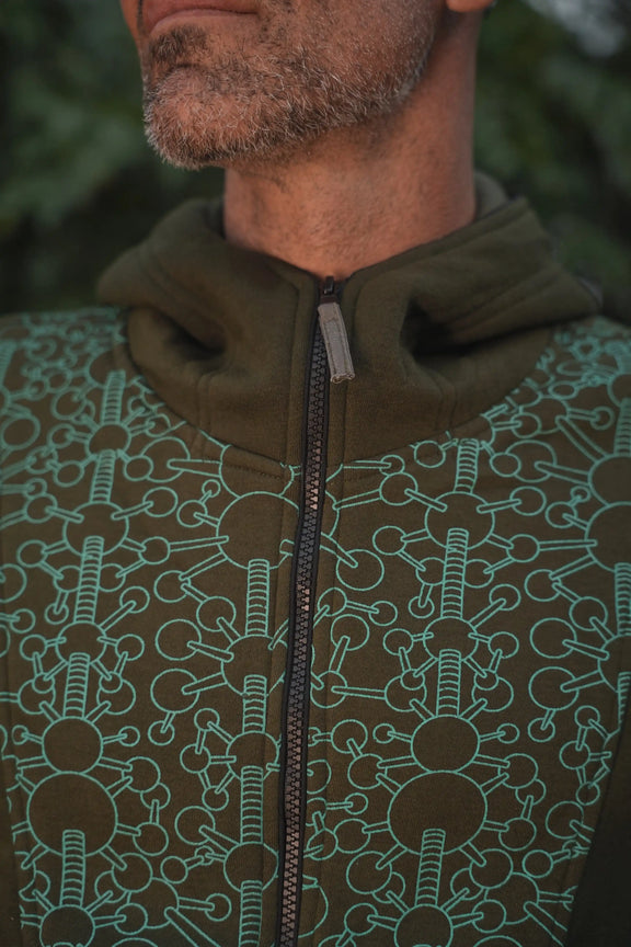 Close-up of the repeating geometric pattern on the Fractal Gravity hoodie in dark olive green