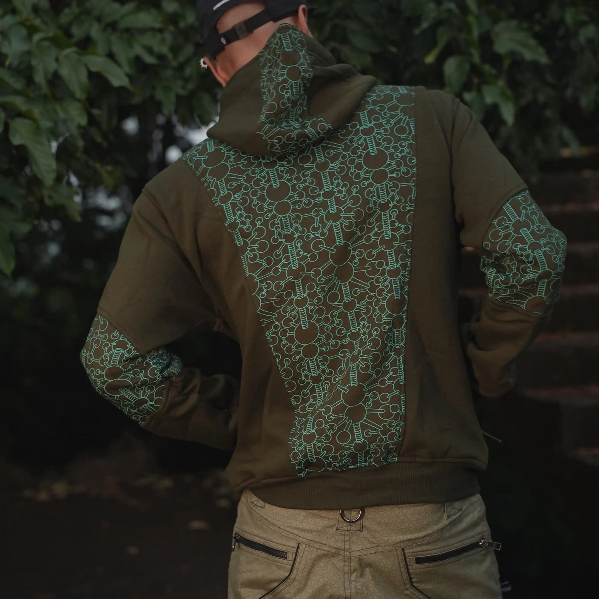 Back view of the Fractal Gravity men's hoodie showing the geometric print across the back, hood and sleeves