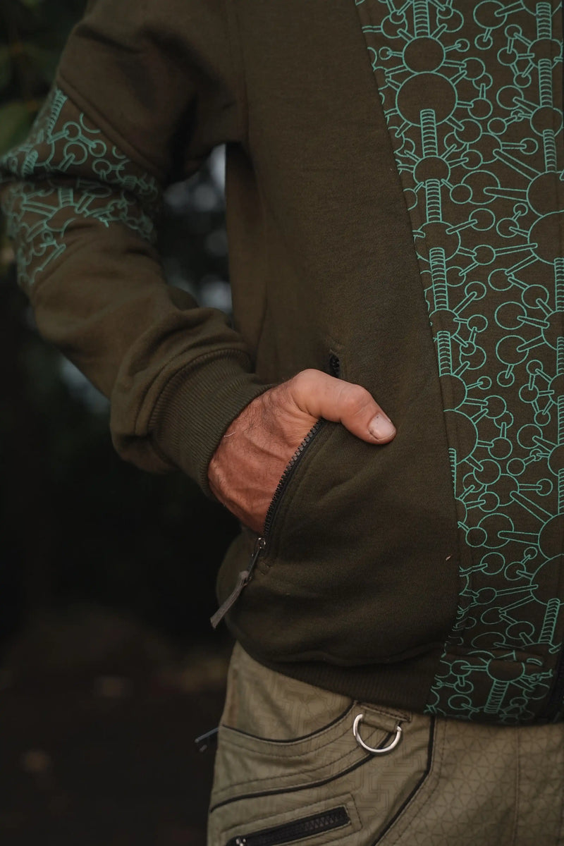 Close-up of a zippered pocket and geometric printed panel on the Fractal Gravity hoodie