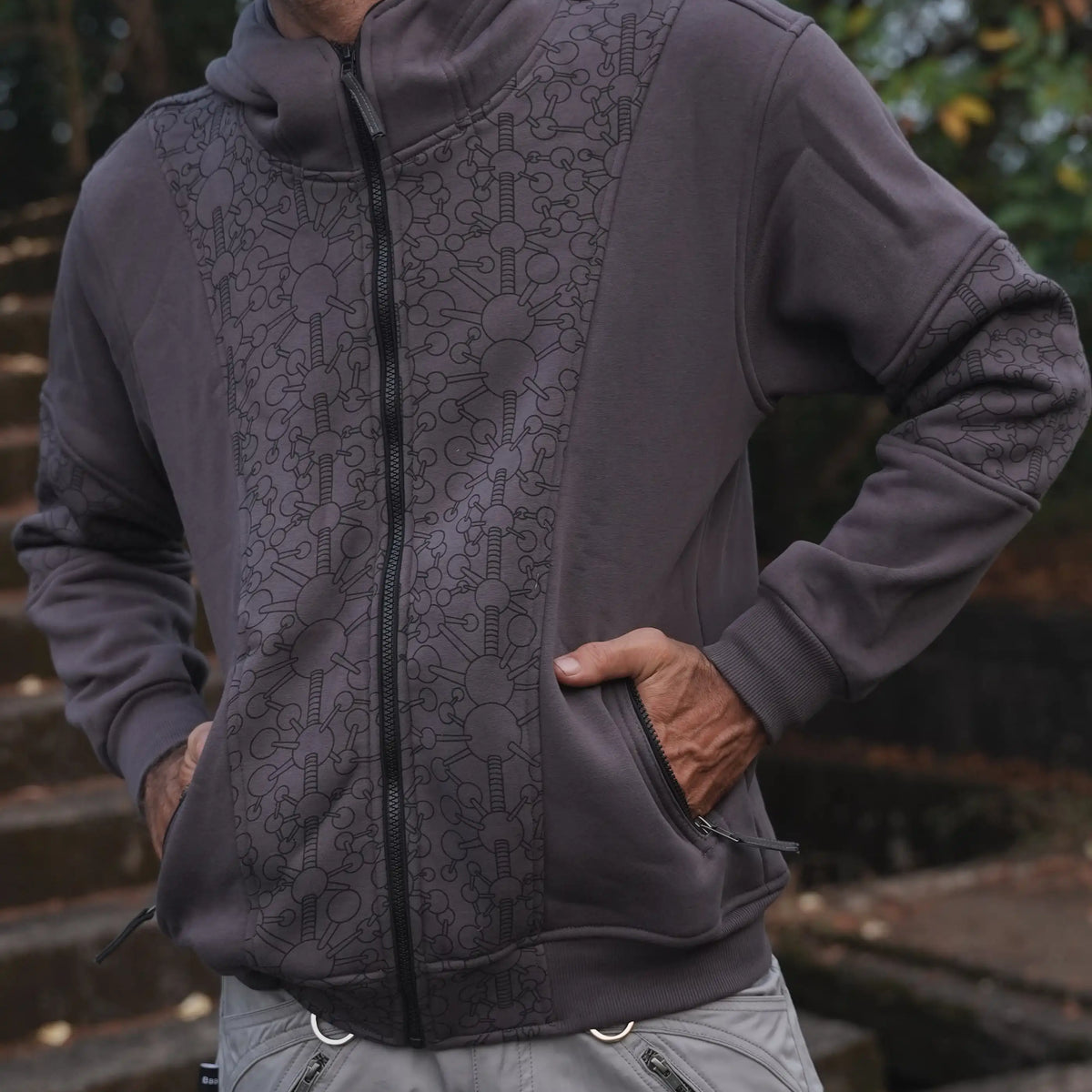 Fractal Gravity grey zip-up hoodie showing patterned front panels and zippered pockets