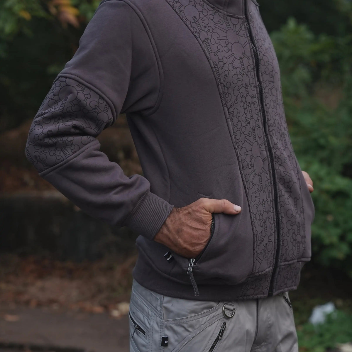 Side view of the Fractal Gravity grey hoodie with geometric sleeve details and front zipper