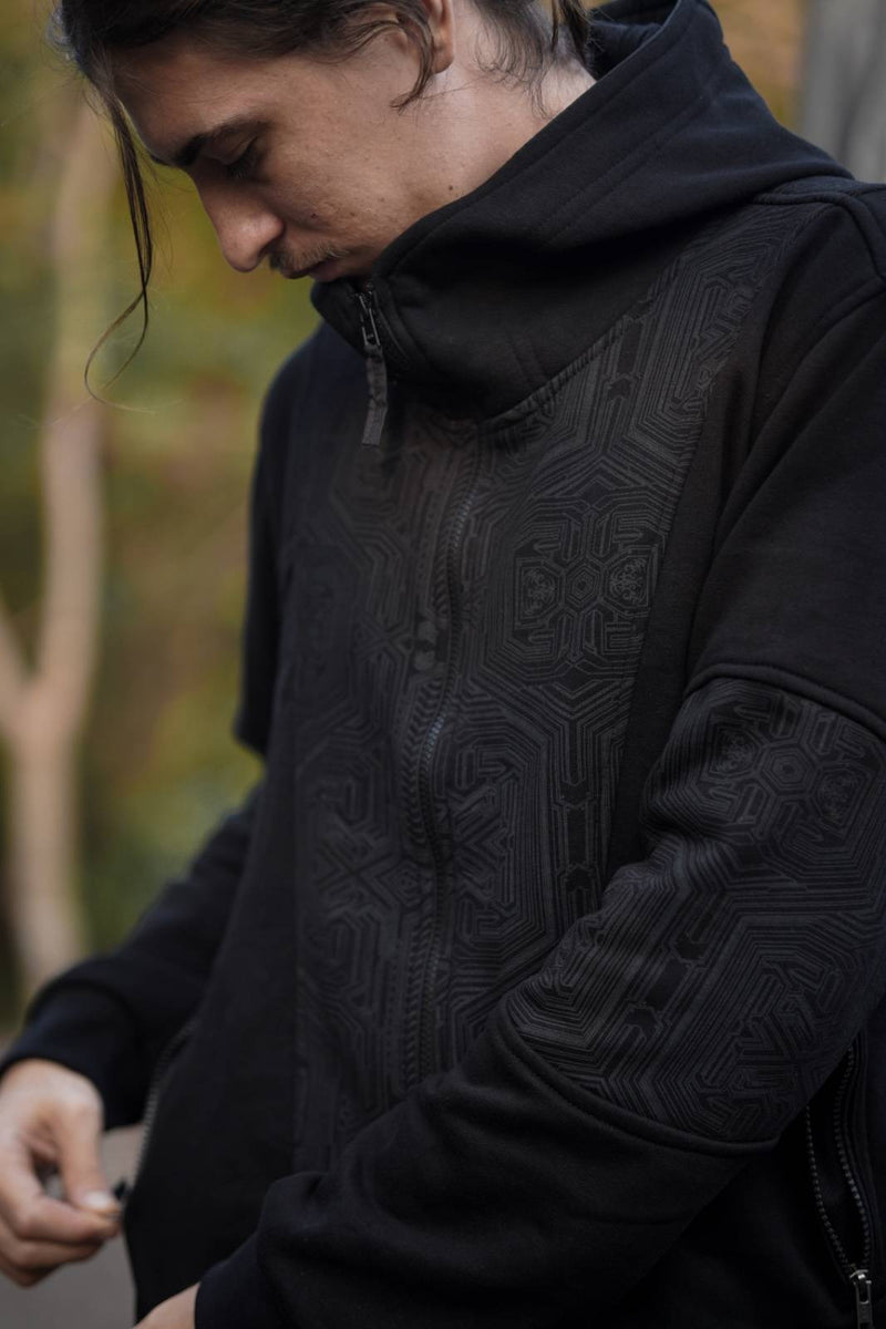 Detailed view of the tonal maze-inspired print on the Metanoia black hoodie