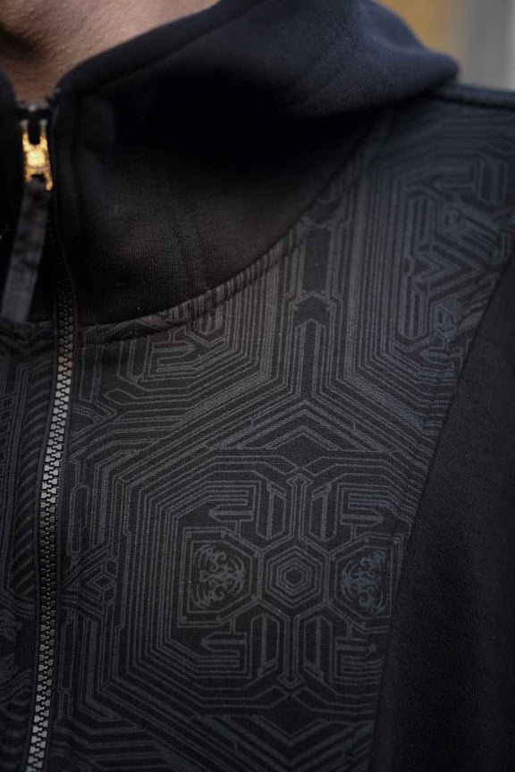 Metanoia hoodie collar and front zipper beside the black geometric shoulder artwork
