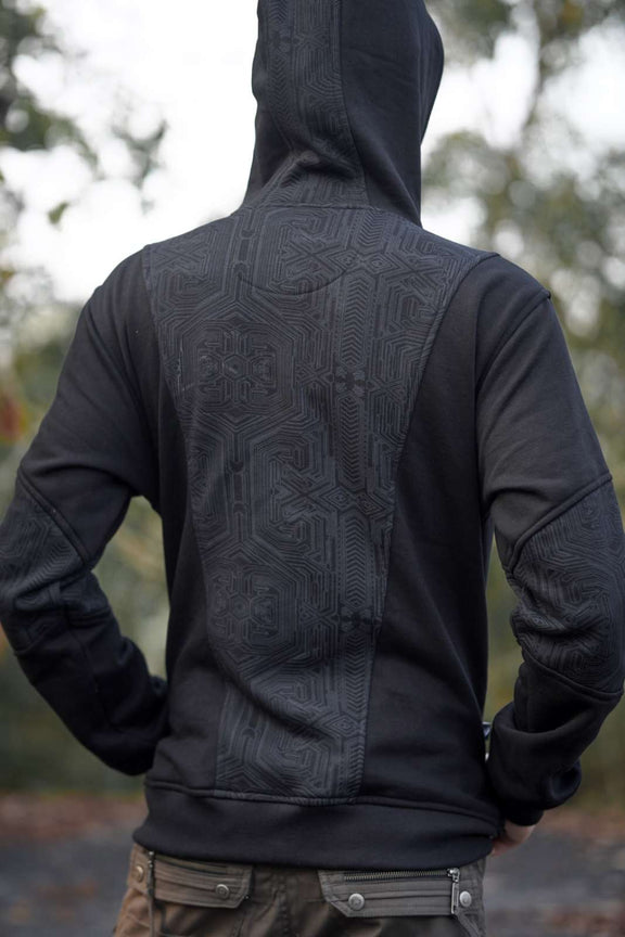 Back view of the Metanoia black hoodie displaying its full-length geometric back panel