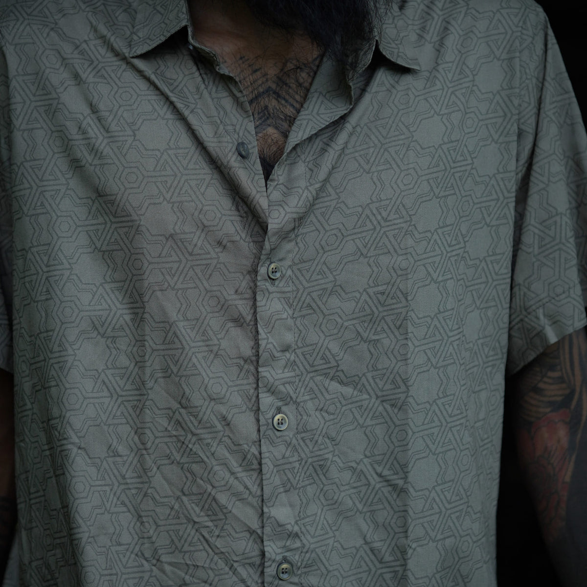 Close-up of olive khaki men's viscose shirt showcasing sacred geometry print and premium viscose fabric