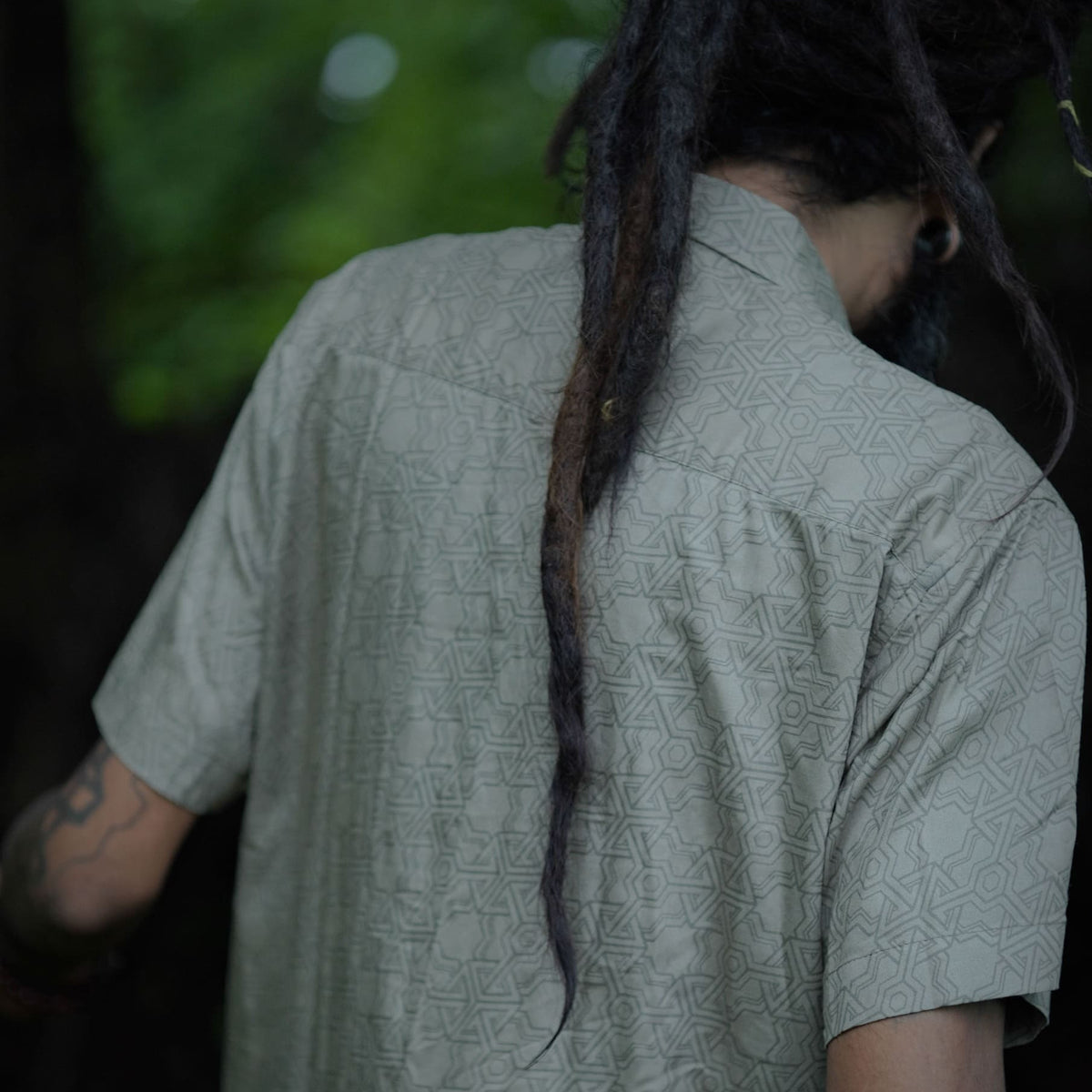 Back view of Pythagoras olive khaki men's viscose shirt displaying full sacred geometry artwork