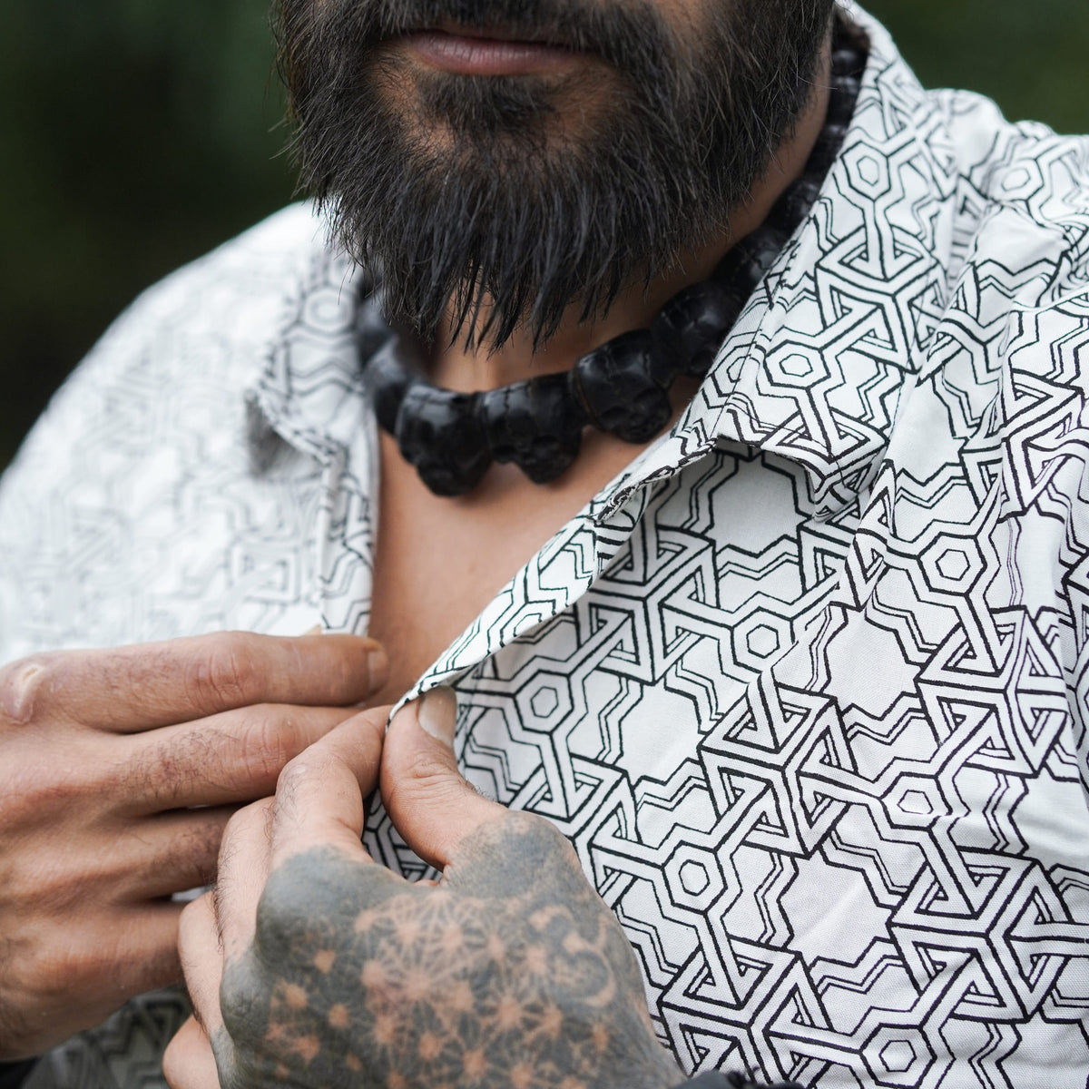 Close-up collar and button detail of Pythagoras white men's viscose shirt with geometric print